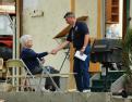 Parkersburg, IA, May 28, 2008 -- FEMA Community Relations Team member, Gary O'Hare, from Oak Grove,Missouri, shakes hands with a Parkersburg resid...