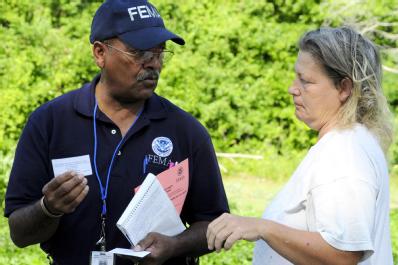 Jeffersonville, GA, May 27, 2008 -- Community Relations (CR) specialist Ernest Stallworth speaks with a homeowner in the disaster area. FEMA CR te...
