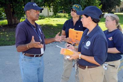 Ft. Pierce, FL, September 16, 2008 -- FEMA Community Relations(CR) Manager Ernie Stallworth speaks with FEMA CR Specialist Annette Moreno-Robinson...