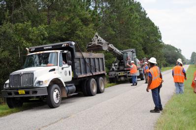 Hilliard, FL, September 18, 2008 -- Nassau County Road and Bridge Department crew clean debris from a drainage ditch which was flooded by Tropical...