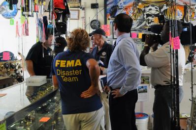 Ft. Pierce, FL, September 16, 2008 -- FEMA Community Relations(CR) Specialist Rene Haldimann speaks with a Tropical Storm Fay flooded shop owner a...