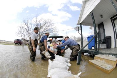 Biscoe, AR, March 26, 2008 -- Locals volunteer in an effort to save houses near the Cache River, a tributary of the White River, which has been ex...
