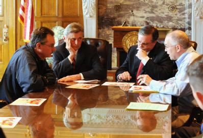 Little Rock, AR, March 31, 2008 -- FEMA Administrator Dave Paulison, left, speaks  with Arkansas Governor Mike Beebe, center and Senator Mark Pryo...