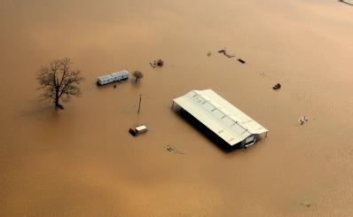 Northeastern Arkansas, AR, March 26, 2008 --  Aerial of farm buildings isolated by flood waters after the Black River flooded follwing torrential ...