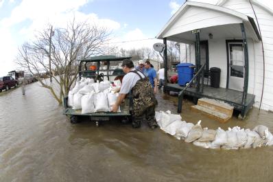 Biscoe, AR, March 26, 2008 -- Locals volunteer stack sandbags in an effort to save houses near the Cache River, a tributary of the White River, wh...