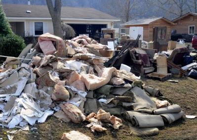 Norfork, AR, March 26, 2008 -- Piles if insulation and carpeting, stripped from the interior of a home inundated by more than 36 inches of White R...