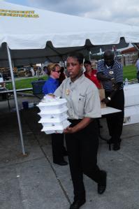 Houma, LA, September 7, 2008 -- Annette Flyod, General Manager,Piccadilly's Restaurant- Baton Rouge, hands out hot meals.  The chain,  like many o...