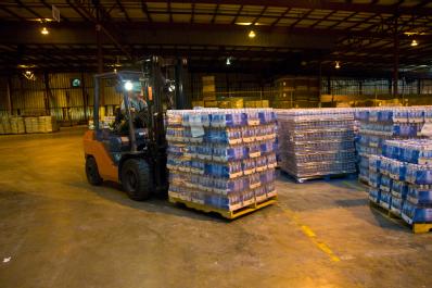 Lufkin, TX, September 2, 2008 -- A member of the Texas Forest Service moves pallets of water in a warehouse in Lufkin, TX.  The warehouse is being...