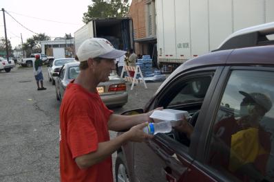 White Castle, LA, September 7, 2008 -- Salvation Army volunteer hands hot meal and water to individual affected  by Hurricane Gustav. Calvin Tolle...