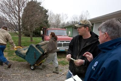 Dutchtown, MO, March 29, 2008 -- FEMA Representative, Jack Heesch talks to flood victim, Josh Williams following the Mississippi river flooding in...