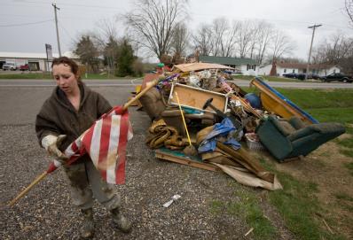 Dutchtown, MO, March 29, 2008 -- Flood victim Kristin Golden helps her neighbor cleanup following the Mississippi river flooding in Cape Girardeau...