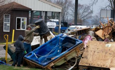 Dutchtown, MO, March 29, 2008 -- Flood victims clean up their homes. William Rickelman helps his neighbor cleanup following the Mississippi river ...