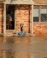 Dutchtown, MO, March 20, 2008 -- Local residents wait for help at their house after collecting some belongings.  The home remains surrounded by fl...