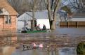 Dutchtown, MO, March 20, 2008 --People in a boat leaving their flooded home.  This small rural community was inundated with fast-moving flood wate...