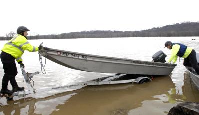 Eureka, MO, March 22, 2008 -- Members of the Missouri Emergency Response Service team, a non-profit that does large animal rescues,  launch a boat...