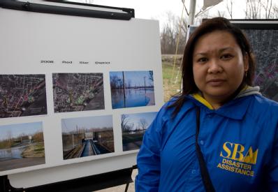 Cape Girardeau, MO, March 27, 2008 -- SBA Representative Olivia Humilde studies before and after flood photos of an area that participated in a FE...