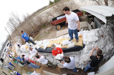 Fenton, MO, March 21, 2008 -- Local residents and area volunteers band together to stack sandbags next to businesses and property on the Meramec R...