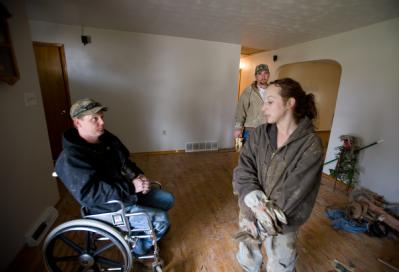 Dutchtown, MO, March 29, 2008 -- Flood victim, Kristin Golden, helps her neighbor Josh Williams clean up  following the Mississippi river flooding...