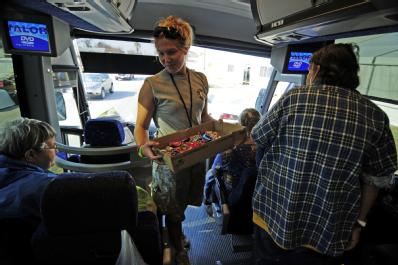 Galveston, TX, September 30, 2008 -- AmeriCorps volunteer Tara Williams offering snacks to evacuees waiting to disembark after a long bus ride. Hu...