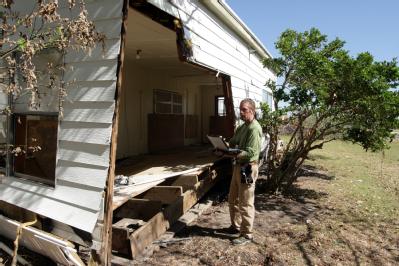 Shoreacres, TX, October 8, 2008 -- FEMA House Inspector Michael Lane examines one of the homes on Miramiar Drive that was damaged by Hurricane Ike...