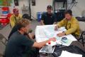 Charlton County, GA, May 17, 2007 -- The Incident Commander (right) explains the extent of the Big Turnaround Fire to the incoming crew.  The Sout...