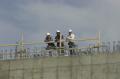 Arlington, VA, March 7, 2002 -- Construction workers takes a break while doing work on top of the Pentagon. The reconstruction is a result of a te...
