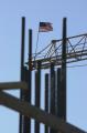 Arlington, VA, March 7, 2002 --  A flag waves in the wind which is on top of a crane used in reconstruction efforts at the Pentagon.  Rebar is in ...