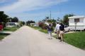 Ft. Pierce, FL, September 16, 2008 -- FEMA Public Information Officer(PIO) Renee Bafalis and a television news crew walk through a neighborhood wh...