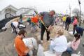 Fenton, MO, March 21, 2008 -- Local residents and area volunteers band together to fill sand bags and stack them next to businesses and property o...