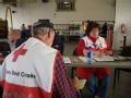 Windsor, CO, May 23, 2008 -- Red Cross representatives compare notes in the town's fire station the day after a tornado struck Windsor, Colorado. ...