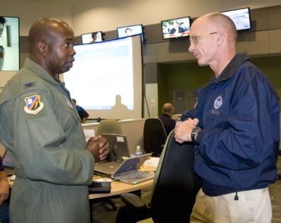 San Antonio, TX, August 29, 2008 -- Gerry Stoler, FEMA liaison for the Alamo Operations center talks with Col. M.L. Mullen, the Texas Air National...