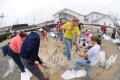 Fenton, MO, March 21, 2008 -- Local residents and area volunteers band together to fill sand bags and stack them next to businesses and property o...