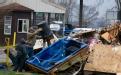 Dutchtown, MO, March 29, 2008 -- Flood victims clean up their homes. William Rickelman helps his neighbor cleanup following the Mississippi river ...