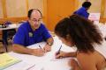 Houston, TX, October 1, 2008 -- Small Business Administration (SBA) customer service representative Alfred Mesa helps an applicant fill out SBA fo...
