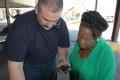 Harris County, TX, October 1, 2008 -- Congresswoman Sheila Jackson-Lee gets help from FEMA's Deputy Area Field Office (AFO) Director Regis Phelan ...