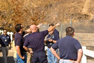 Yorba Linda, CA, November 20, 2008 -- Federal Coordinating Officer, Mark Neveau, and local City officials look at damage caused by the recent wild...