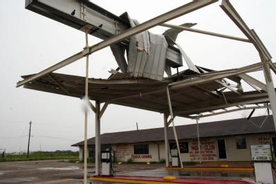 Brownsville, TX, July 24, 2008 -- This gas station's roof and front highway signs have been damaged and twisted by Hurricane Dolly. Closed for bus...