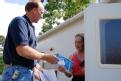 Pascagoula, MS, July 31, 2008 - -FEMA housing advisor Bobby Russell gives a NOAA Weather Radio to Gloria Thompson. FEMA is issuing weather radios ...