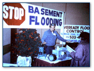 Graphic of a man demonstrating equipment underneath a banner that reads Stop Basement Flooding.