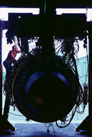Image of peron repairing aircraft engine