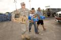 San Benito, Texas, July 27, 2008 -- Army National Guard Capt. Messenger carries water and packaged meals for a family that was affected by Hurrica...