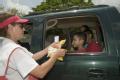 Edinburg, TX, July 31, 2008 -- A Red Cross volunteer gives some snacks to a child whose family was waiting in line at a food distribution site in ...