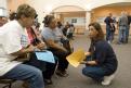 Harlingen, TX, August 3, 2008 -- A FEMA employee talks to residents in the DRC in Harlingen, TX DRC who are applying for assistance after their ho...