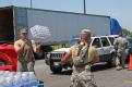 Brownsville,TX,  July 27, 2008 -- Two dozen bottles of water are tossed from one Guardsman to another to speed the delivery to awaiting residents,...