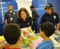Pharr,Tx August 22, 2008--A FEMA employee gives out coloring books at a local health fair in Pharr, TX.  FEMA is reaching out to the communities a...