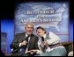 President George W. Bush shares a laugh with panel participant Helen Robinette during a conversation about Medicare prescription drug benefits at the Etta & Joseph Miller Performing Arts Center in Jefferson City, Mo., Tuesday, April 11, 2006.  White House photo by Eric Draper