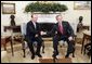 President George W. Bush welcomes Romanian President Traian Basescu to the Oval Office Wednesday, March 9, 2005. President Bush and President Basescu met to discuss regional security and diplomatic issues.  White House photo by Paul Morse