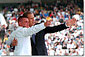 President George W. Bush waves to family and friends of a cadet during graduation ceremonies at the Naval Academy in Anapolis, MD Friday, May 25. WHITE HOUSE PHOTO BY PAUL MORSE