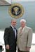 President George W. Bush met Dean H. Gesme, Sr., upon arrival in Cedar Rapids, Iowa, on Tuesday, July 20, 2004. Gesme is an active volunteer with SCORE, a volunteer management counseling program sponsored by the U.S. Small Business Administration.