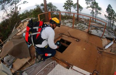 Navarre, FL, September 16, 2004-- Urban Search and Rescue workers search for any survivors in a house that was destroyed by Hurricane Ivan.  A the...